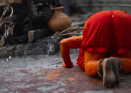 Hindu devotee covered with orange color praying in  Lal Kach festival, Dhaka Division, Munshiganj Sadar, Bangladesh