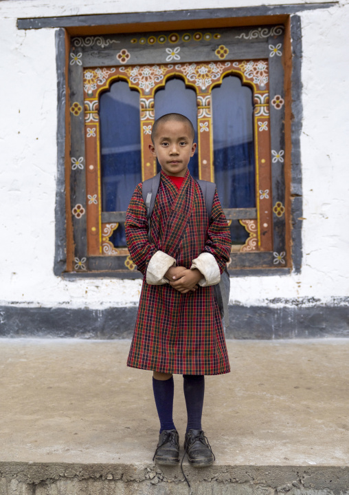 Bhutanese novice monk back from school in Nyenzer Lhakhang, Thedtsho Gewog, Wangdue Phodrang, Bhutan