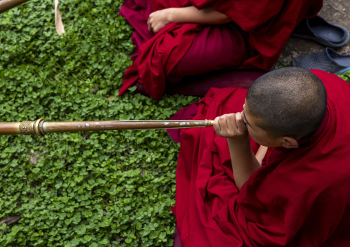 Bhutanese novices monks playing horns in Nyenzer Lhakhang, Thedtsho Gewog, Wangdue Phodrang, Bhutan