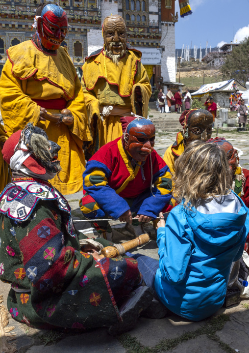 Atsara showing a wooden phallus to a tourist at the Ura Yakchoe festival, Bumthang, Ura, Bhutan