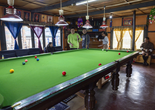 Group of bhutanese friends having fun while playing pool, Chhoekhor Gewog, Bumthang, Bhutan