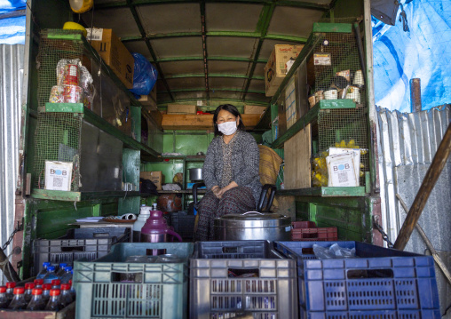 Bhutanese woman selling drinks in a truck in Chele la Pass, Wangchang Gewog, Paro, Bhutan