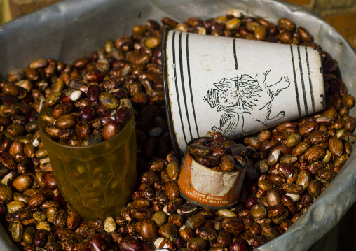 Beans for sale in the mercato with an enamel cup with ethiopian lion, Central Region, Asmara, Eritrea