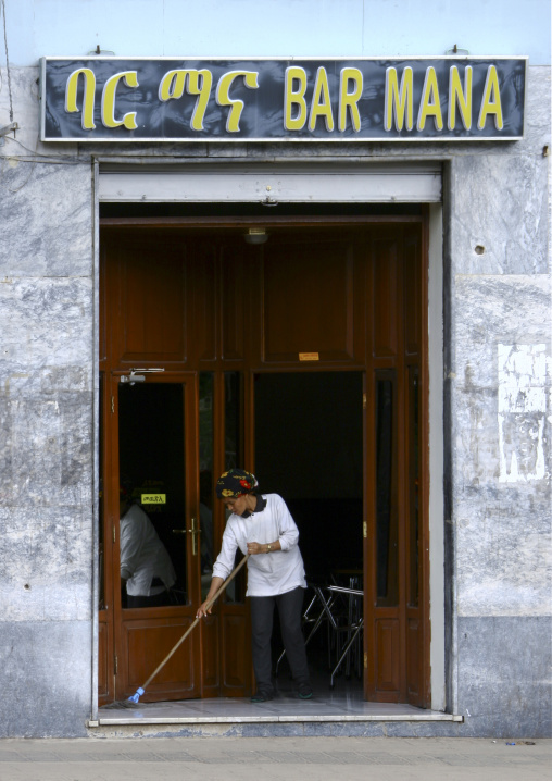 Eritrean cleaning in front of Mana bar, Central Region, Asmara, Eritrea