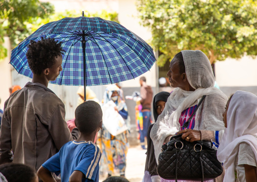 Eritrean man selling umbrellas in the street, Semien-Keih-Bahri, Keren, Eritrea