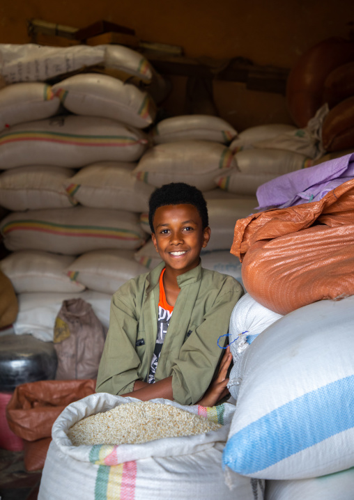 Eritrean boy in a warehouse full of grains bags, Central region, Asmara, Eritrea