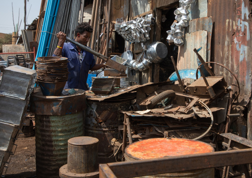 Eritrean man working in the Medebar metal market, Central region, Asmara, Eritrea