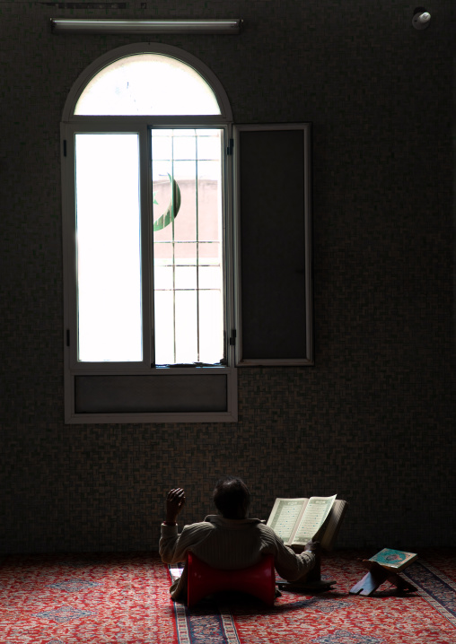 Eritrean man praying in the grand mosque Kulafa al Rashidin, Central region, Asmara, Eritrea