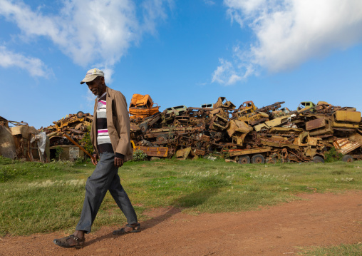 Eritrean man in the military tank graveyard, Central region, Asmara, Eritrea