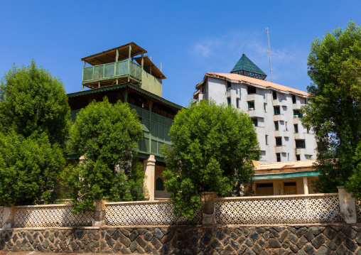 Old colonial building with green wooden balcony near a modern one, Northern Red Sea, Massawa, Eritrea