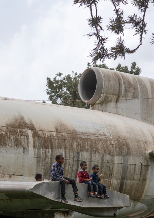 Eritrean children playing on a training mockup plane in expo, Central region, Asmara, Eritrea