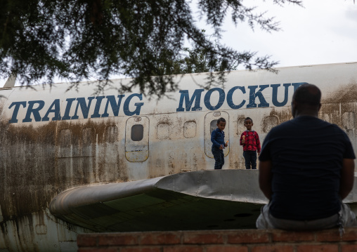 Eritrean children playing on a training mockup plane in expo, Central region, Asmara, Eritrea