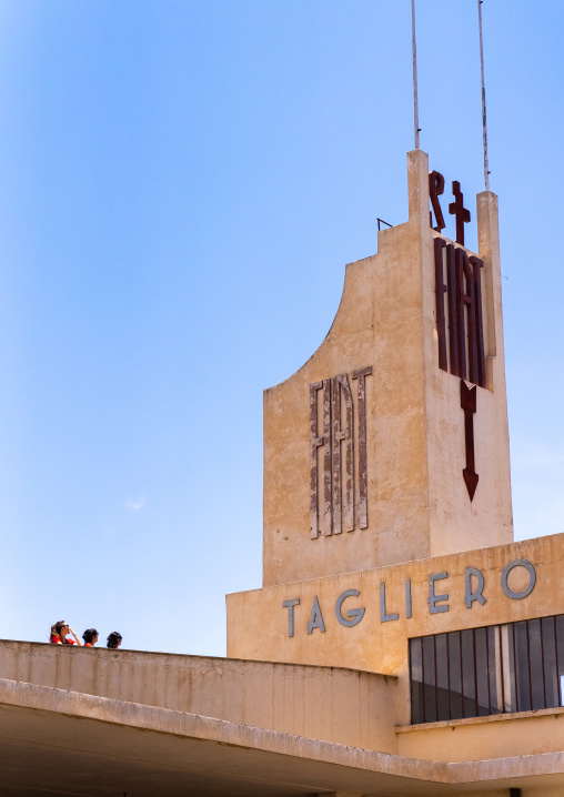 Tourists on FIAT tagliero service station built in 1938, Central region, Asmara, Eritrea