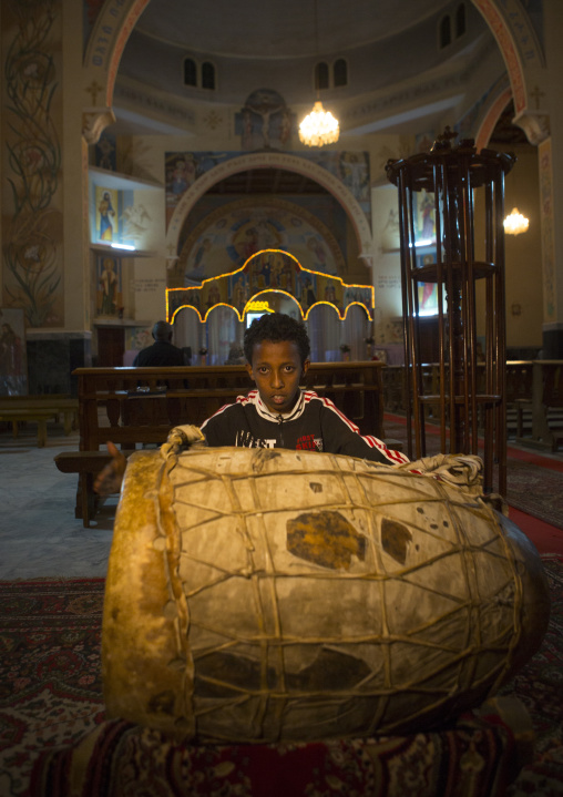 Eritrean boy playing drums in a church, Central Region, Asmara, Eritrea