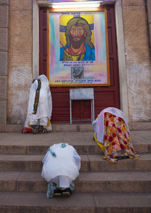 Eritrean women praying in front of a church, Central Region, Asmara, Eritrea