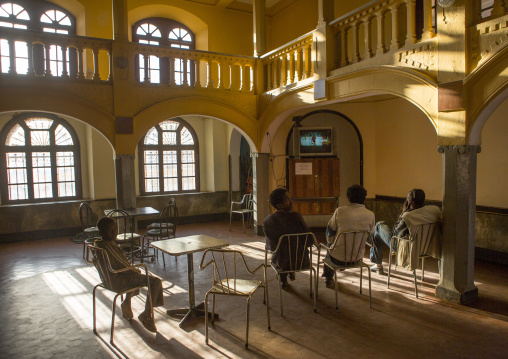 Eritrean men looking at television inside Opera house bar, Central Region, Asmara, Eritrea