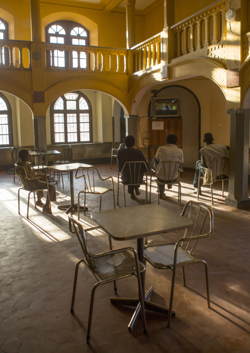 Eritrean men looking at television inside Opera house bar, Central Region, Asmara, Eritrea