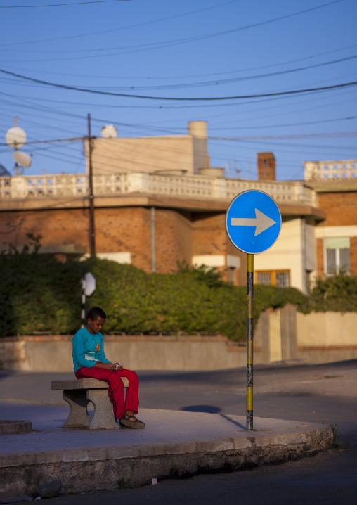 Eritrean boy sitting on a bench, Central Region, Asmara, Eritrea