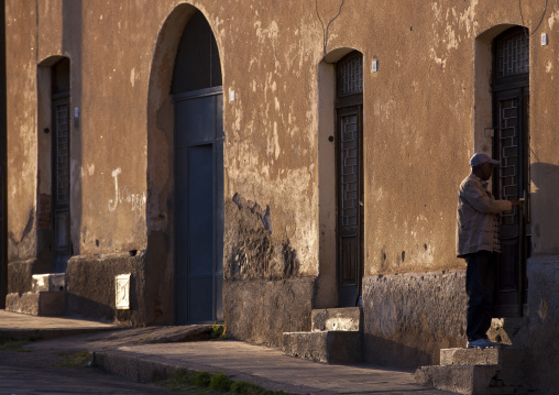 Eritrean man entering his home, Central Region, Asmara, Eritrea