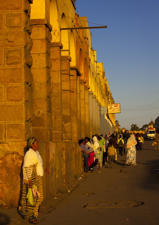 Eritrean people waiting for a bus in front of the arcades, Central Region, Asmara, Eritrea