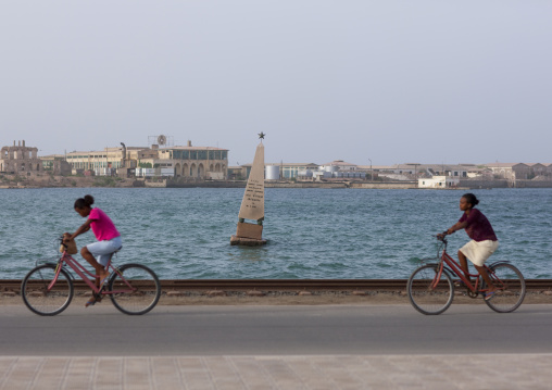 Eritrean girls riding bicycles on the causeway, Northern Red Sea, Massawa, Eritrea