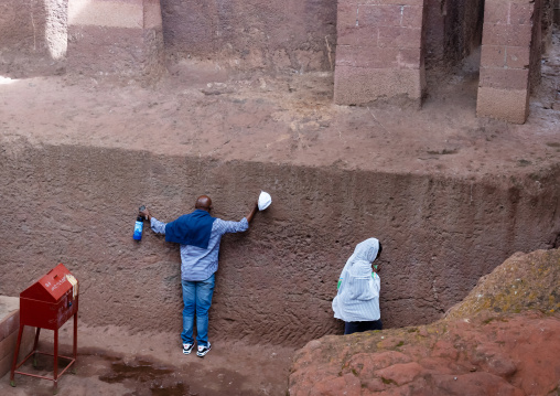 Ethiopian people praying in Biete Medhane Alem rock-hewn church, Amhara Region, Lalibela, Ethiopia