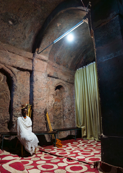 Ethiopian monk inside a rock-hewn church, Amhara Region, Lalibela, Ethiopia