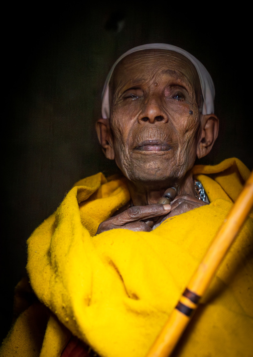 Old ethiopian nun in yellow shawl, Amhara Region, Lalibela, Ethiopia