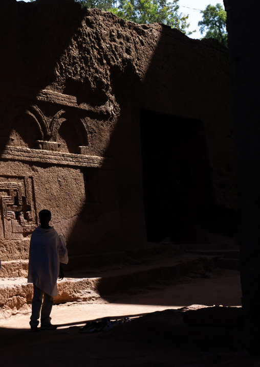 Ethiopian man outside Biete Meskel rock-hewn church, Amhara Region, Lalibela, Ethiopia