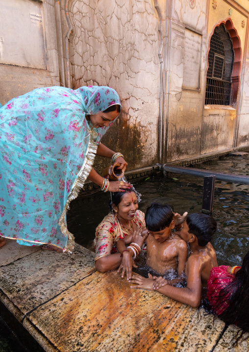 Indian pilgrims having a bath in Galtaji temple aka monkey temple, Rajasthan, Jaipur, India