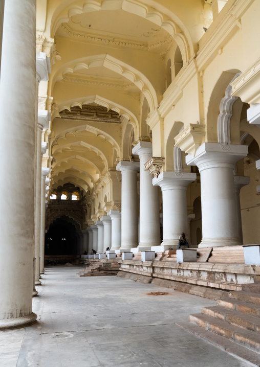 People sit in the Pillared hall of Thirumalai Nayakar Palace, Tamil Nadu, Madurai, India