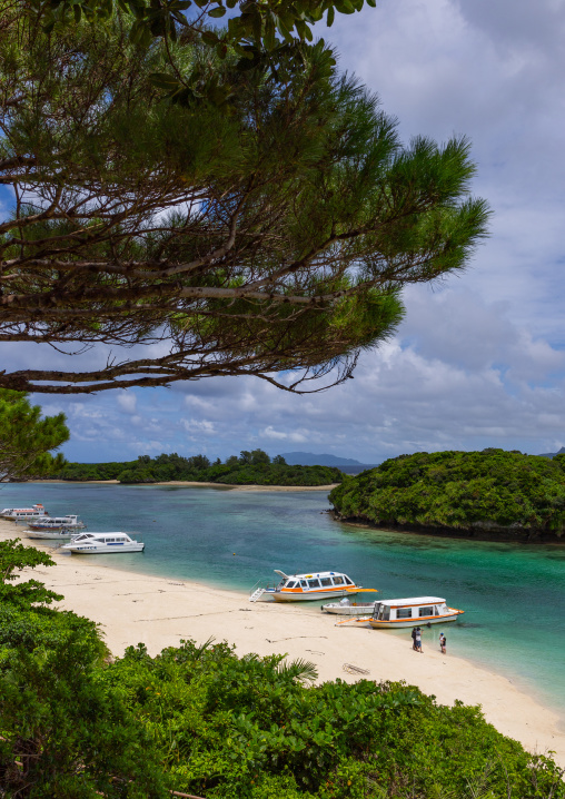 Glass bottom boats in tropical lagoon with clear blue water in Kabira bay, Yaeyama Islands, Ishigaki, Japan