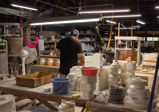 Artisans working in Genemongama porcelain atelier, Kyushu region, Arita, Japan