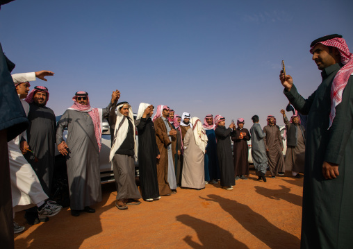 Saudi men dancing in line during King Abdul Aziz Camel Festival, Riyadh Province, Rimah, Saudi Arabia