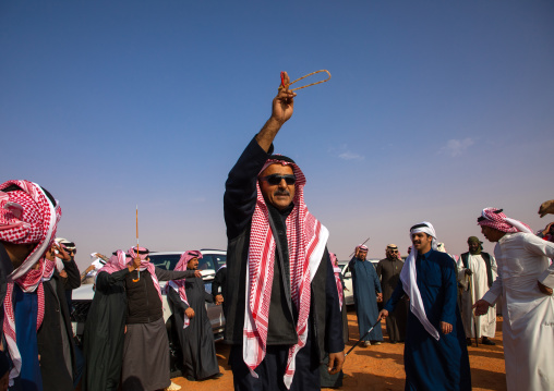 Saudi men dancing during King Abdul Aziz Camel Festival, Riyadh Province, Rimah, Saudi Arabia