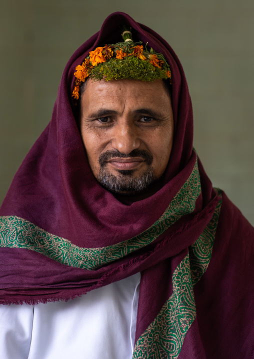 Portrait of a flower man wearing a floral crown on the head, Asir province, Sarat Abidah, Saudi Arabia