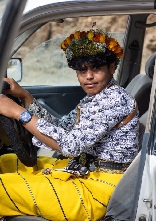 Portrait of a flower man wearing a floral crown on the head, Asir province, Sarat Abidah, Saudi Arabia