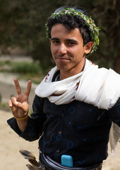 Portrait of a flower man wearing a floral crown on the head, Asir province, Sarat Abidah, Saudi Arabia