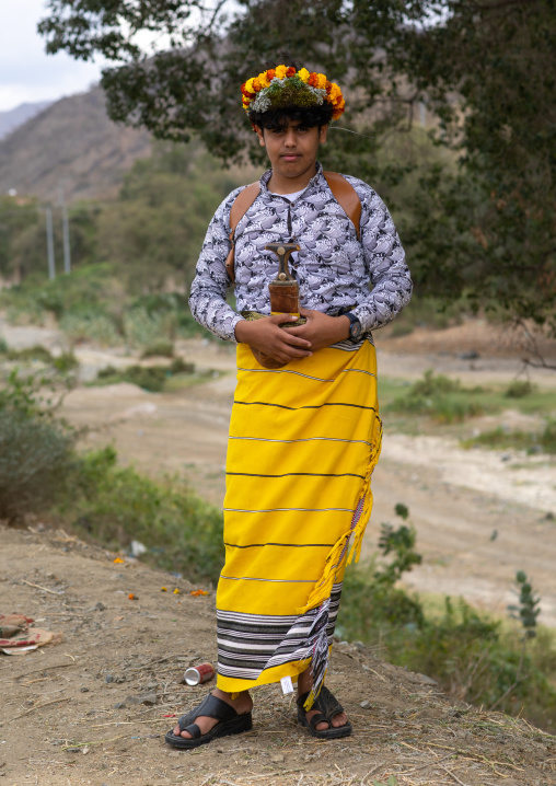 Portrait of a flower man wearing a floral crown on the head, Asir province, Sarat Abidah, Saudi Arabia