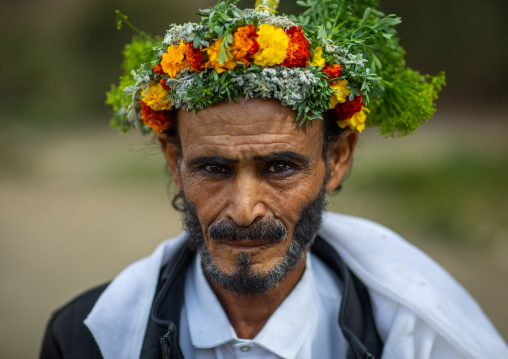 Portrait of a flower man with a floral crown on the head and kohl on his eyes, Asir province, Sarat Abidah, Saudi Arabia