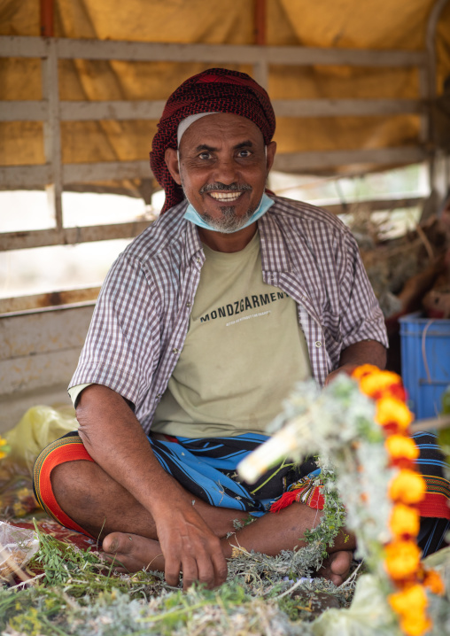 Man selling floral crowns in a market, Jazan province, Addayer, Saudi Arabia