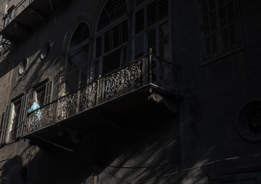 Woman standing on the balcony of an old lebanese heritage house, Beirut Governorate, Beirut, Lebanon