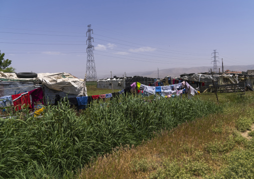 Surian refugees camp under a electric pylon, Beqaa Governorate, Rayak, Lebanon