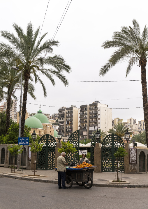 Man selling fruits in front of Taynal Mosque, North Governorate, Tripoli, Lebanon