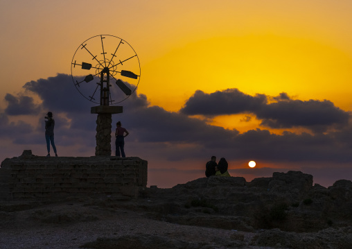 Windmill in a salt production site in the sunset, North Governorate, Tripoli, Lebanon