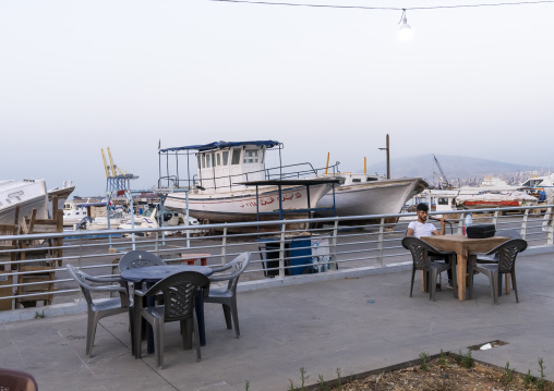 Man smoking shisha along the port, North Governorate, Tripoli, Lebanon