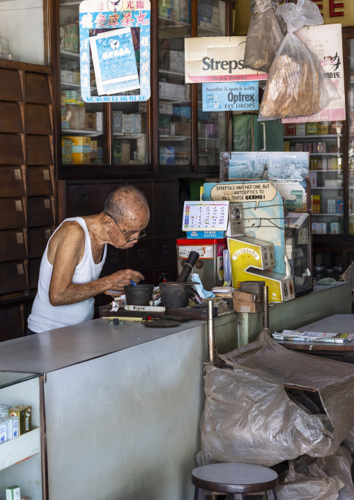 Old man in a chinese medical hall, Penang island, George Town, Malaysia