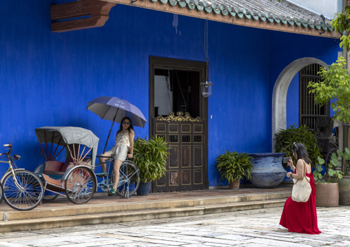 Asian tourists taking pictures in The Cheong Fatt Tze Chinese Mansion, Penang island, George Town, Malaysia