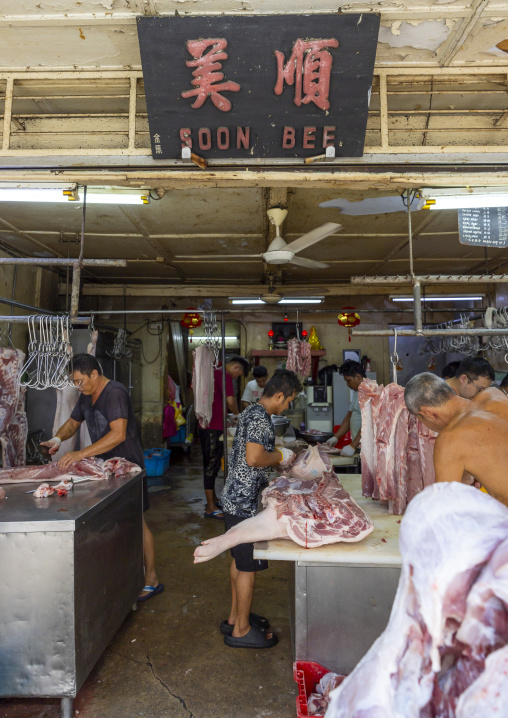 Butchers cutting pork head, Penang island, George Town, Malaysia