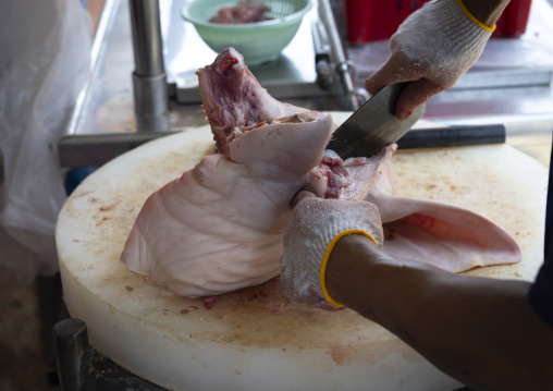 Butcher cutting pork head, Penang island, George Town, Malaysia